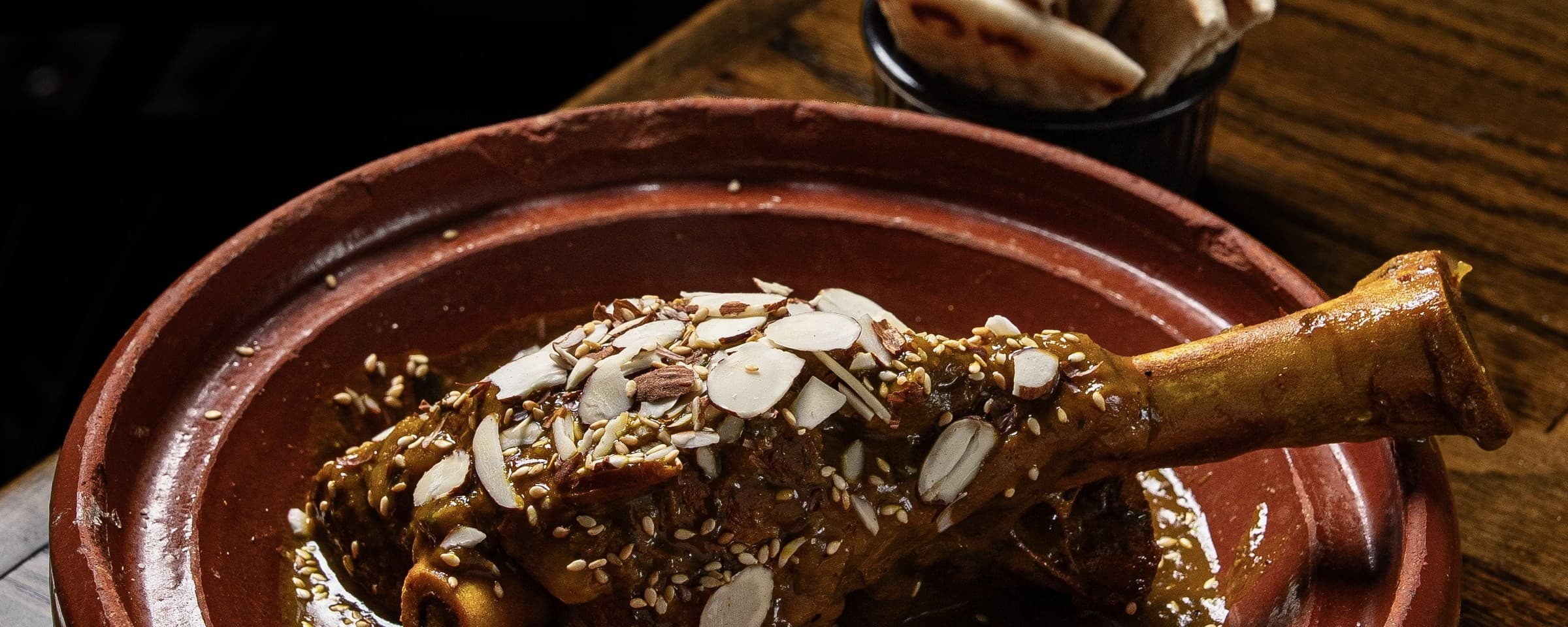 Lamb tagine at Cybel: slow-cooked lamb shank with onions, Moroccan spices, apricots and almonds, served in a clay tagine