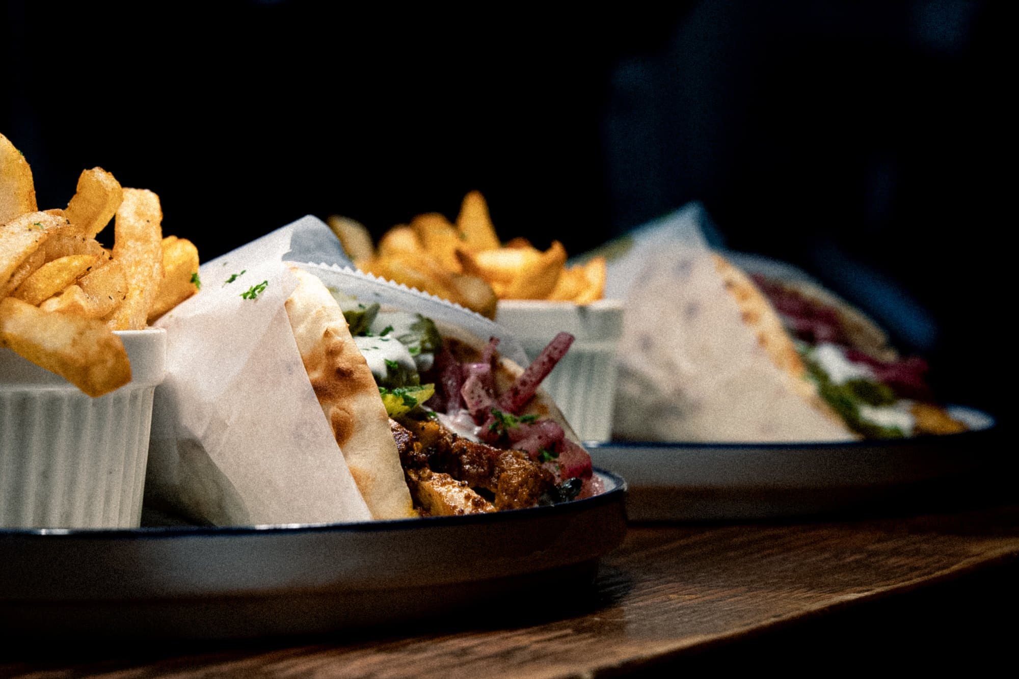Chicken shawarma and falafel pitas with gourmet fries on a platter at Cybel in St. Petersburg